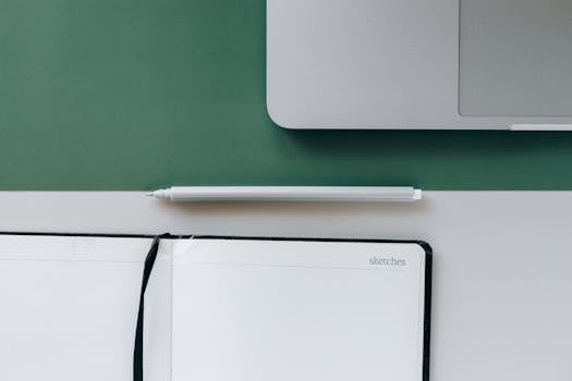 cluttered desk with gadgets and papers