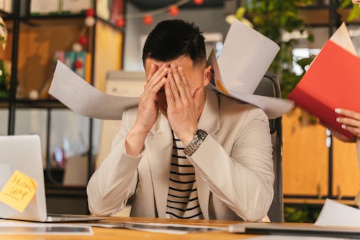 stressed young professional overwhelmed by notifications