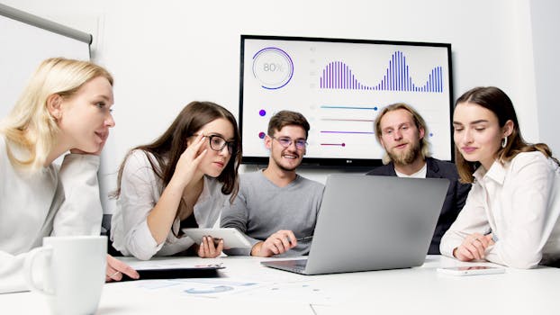 image of a young professional working at a desk with multiple screens