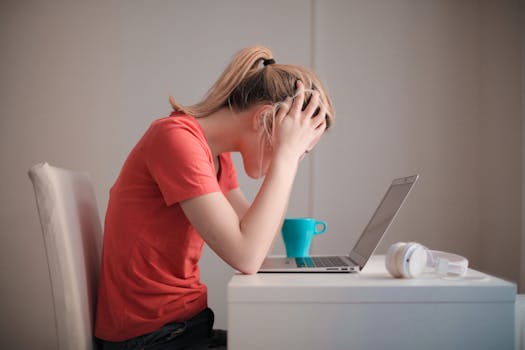 person working on a laptop at a desk