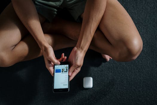 person meditating with a phone nearby