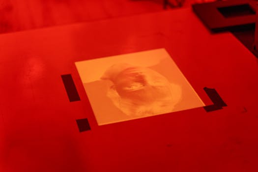 A serene image of a person developing photos in a darkroom